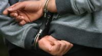 Close up of a juvenile male wearing handcuffs